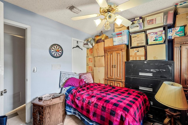 bedroom with a textured ceiling and ceiling fan