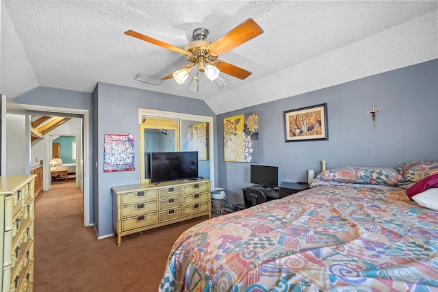 carpeted bedroom with ceiling fan, lofted ceiling, a closet, and a textured ceiling