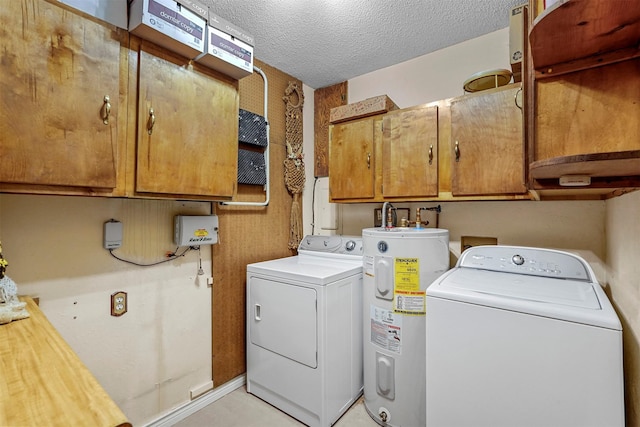 washroom featuring cabinets, separate washer and dryer, electric water heater, and a textured ceiling