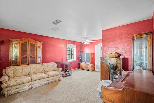 carpeted living room with ceiling fan