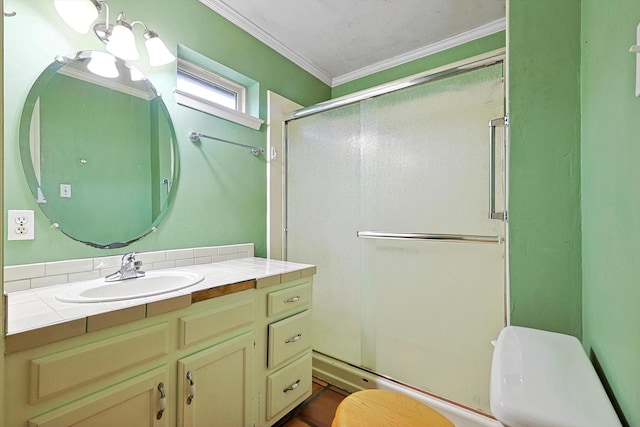 bathroom featuring vanity, crown molding, a shower with door, and toilet