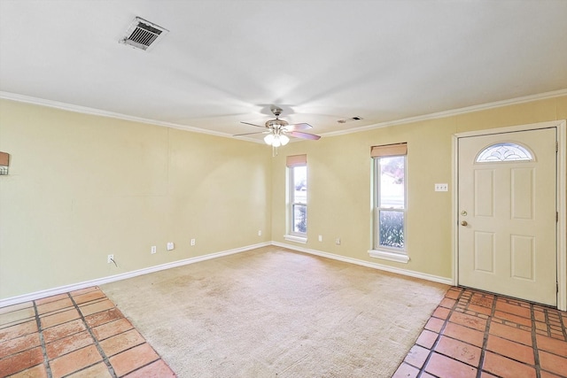 carpeted entryway featuring crown molding and ceiling fan