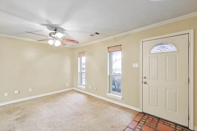 carpeted entryway with ceiling fan and ornamental molding