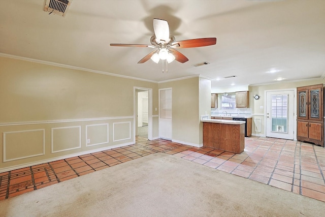 kitchen featuring ornamental molding, light carpet, ceiling fan, and kitchen peninsula