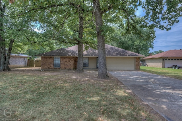 ranch-style home with a garage and a front yard