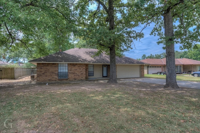 single story home with cooling unit, a garage, and a front yard