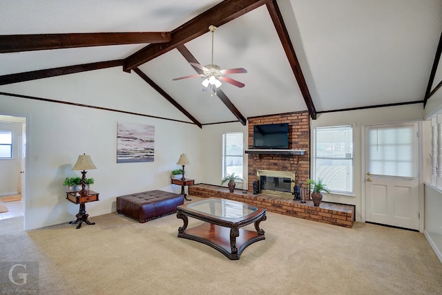 carpeted living room with ceiling fan, a fireplace, and lofted ceiling with beams