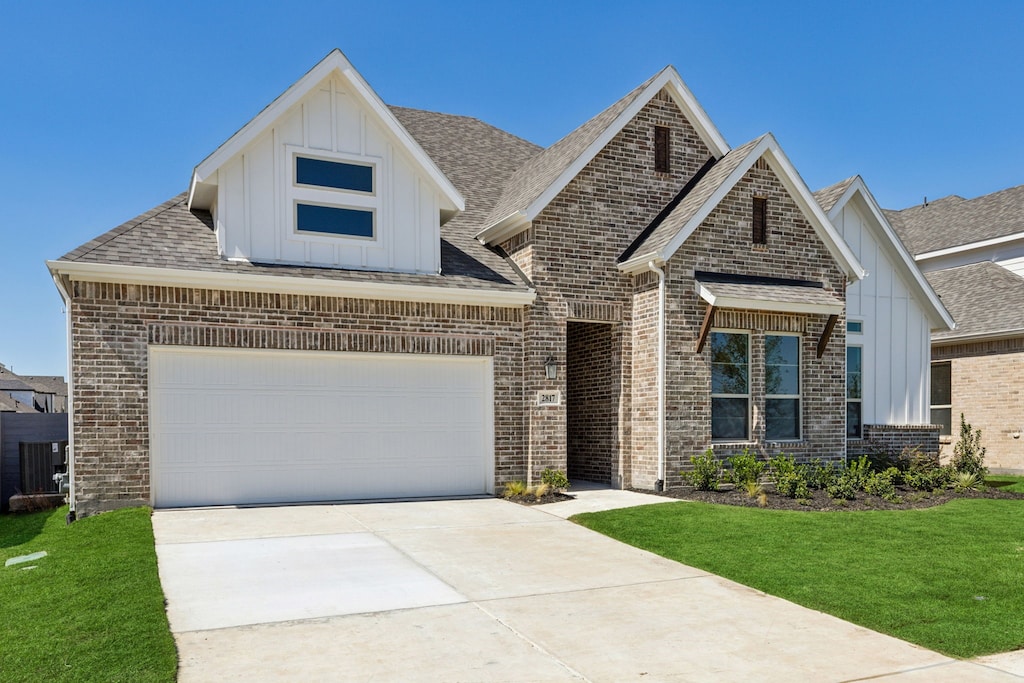 view of front of house with a garage and a front lawn