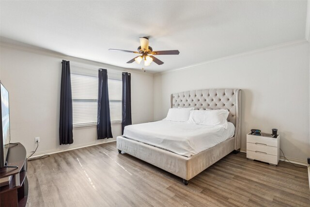 bedroom with hardwood / wood-style flooring, ceiling fan, and ornamental molding