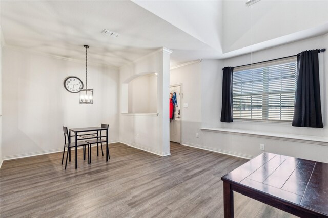 dining space with hardwood / wood-style floors and a notable chandelier