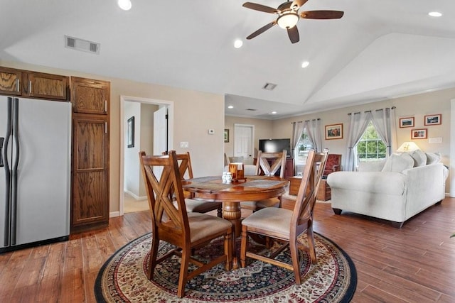 dining room featuring ceiling fan, lofted ceiling, and dark hardwood / wood-style flooring