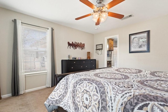 carpeted bedroom with multiple windows and ceiling fan