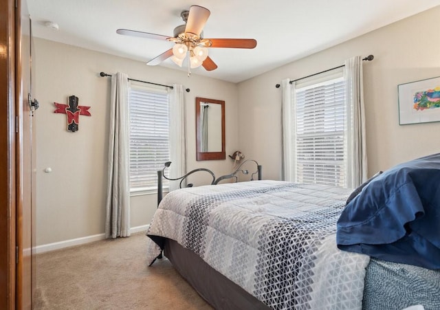 bedroom featuring light colored carpet and ceiling fan