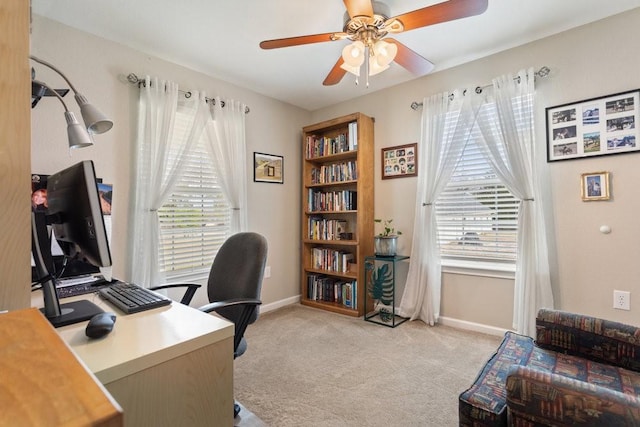 carpeted office featuring ceiling fan