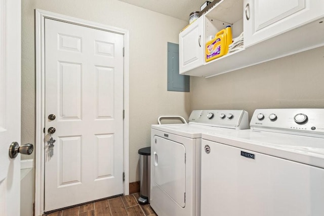 laundry room with cabinets, washing machine and clothes dryer, and electric panel