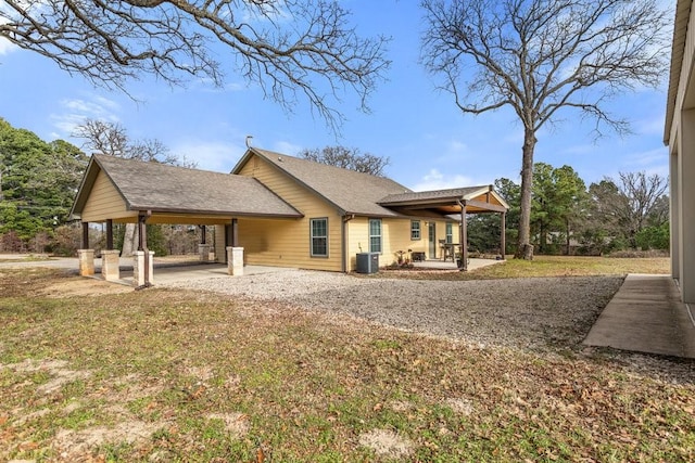 back of property with a patio, central AC unit, and a lawn