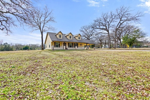 cape cod home with a front yard