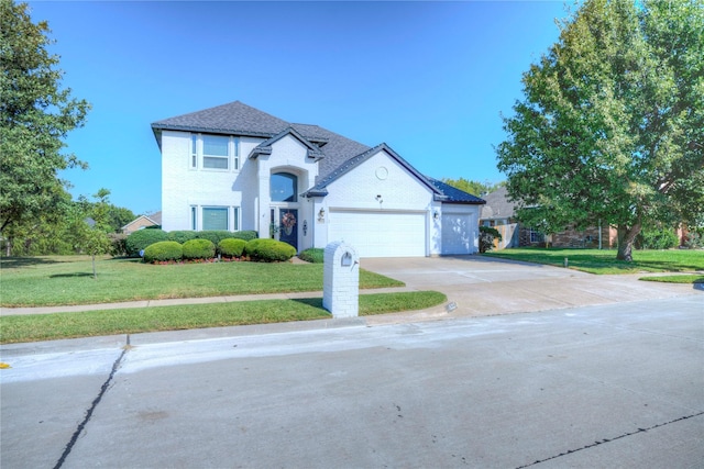 view of front facade featuring a garage and a front lawn