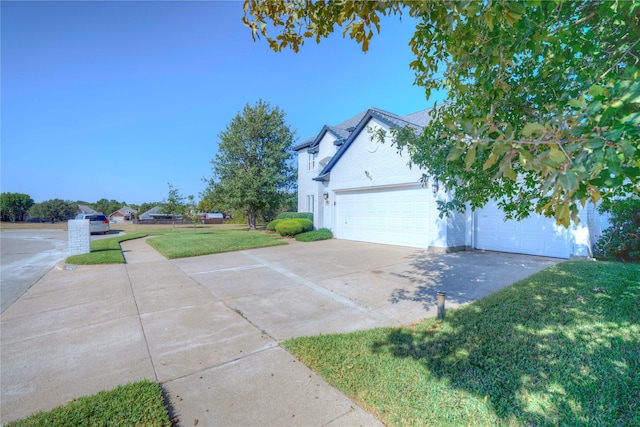 view of side of home with a yard and a garage