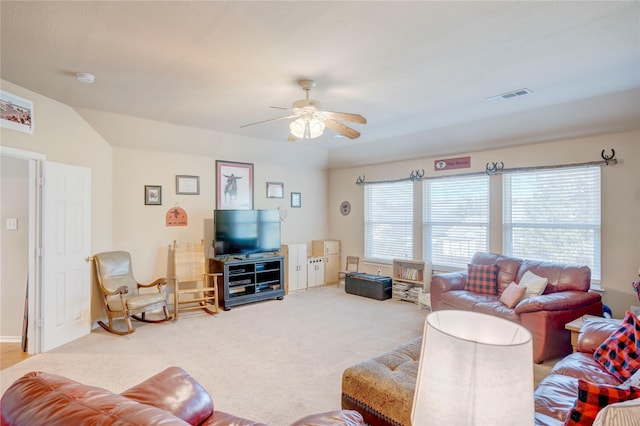 living room with vaulted ceiling, carpet, and ceiling fan