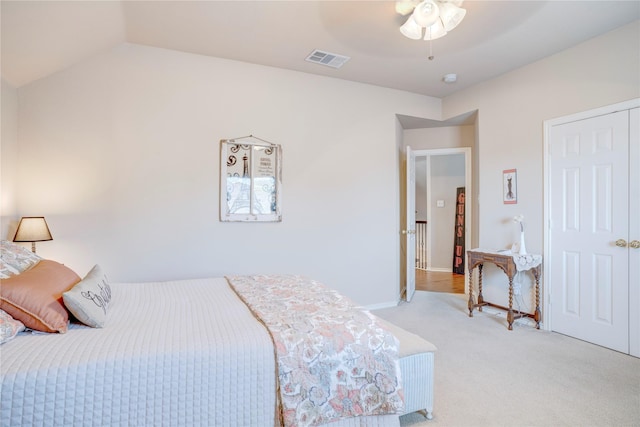 bedroom featuring vaulted ceiling, light colored carpet, and ceiling fan