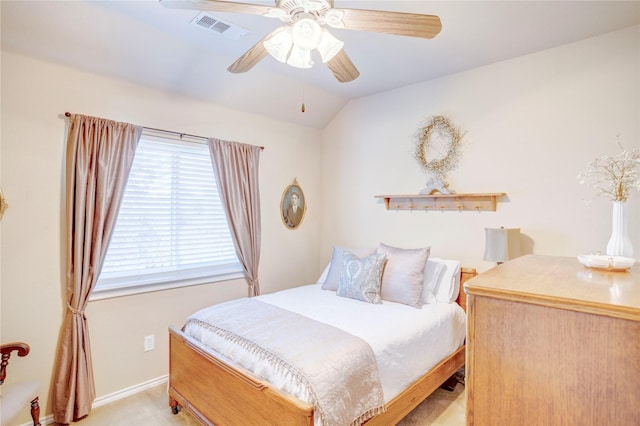 bedroom featuring vaulted ceiling, light colored carpet, and ceiling fan