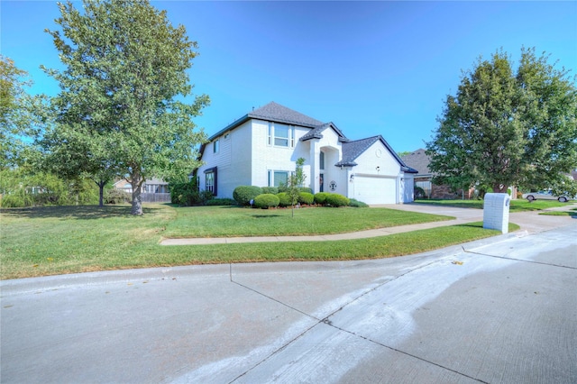 view of front of house with a garage and a front lawn