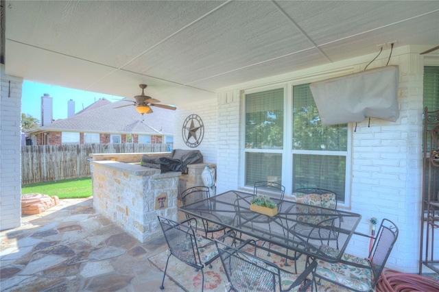 view of patio featuring a grill, an outdoor bar, and ceiling fan