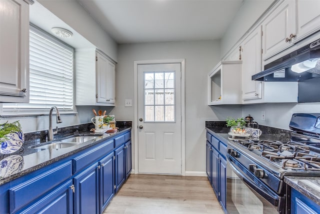 kitchen featuring blue cabinets, sink, white cabinets, and black gas range