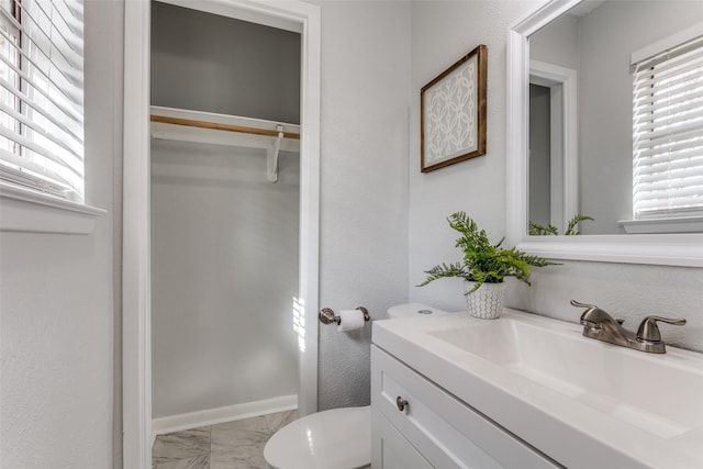 bathroom with vanity, plenty of natural light, and toilet