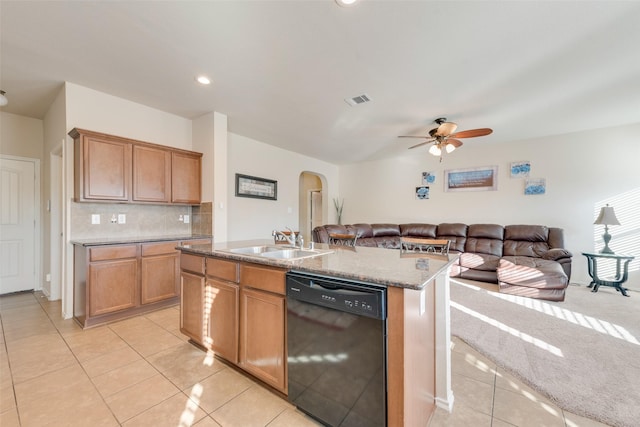 kitchen with dishwasher, sink, decorative backsplash, a kitchen island with sink, and light tile patterned floors