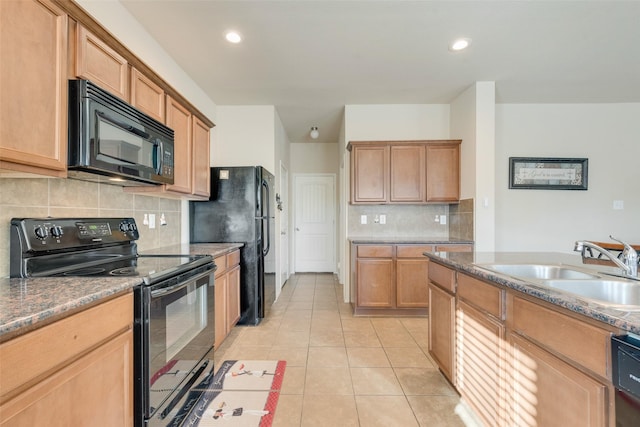 kitchen with sink, light tile patterned floors, black appliances, and decorative backsplash