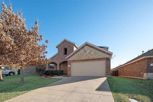 view of front of property featuring a garage and a front lawn