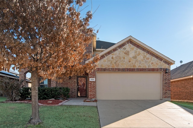 view of front of home with a garage and a front yard