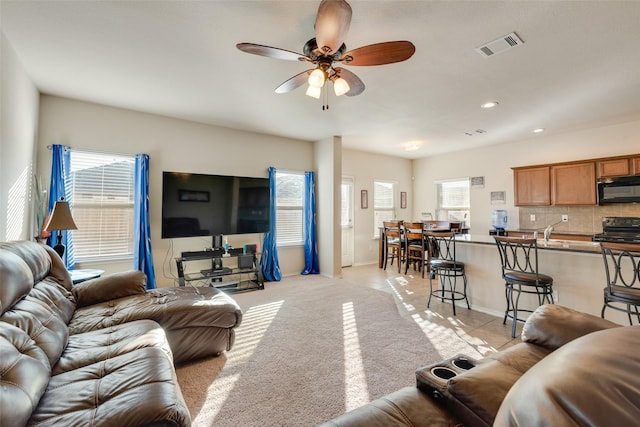 living room with ceiling fan and light carpet