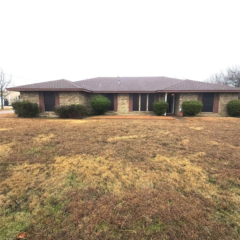 ranch-style house with a front lawn