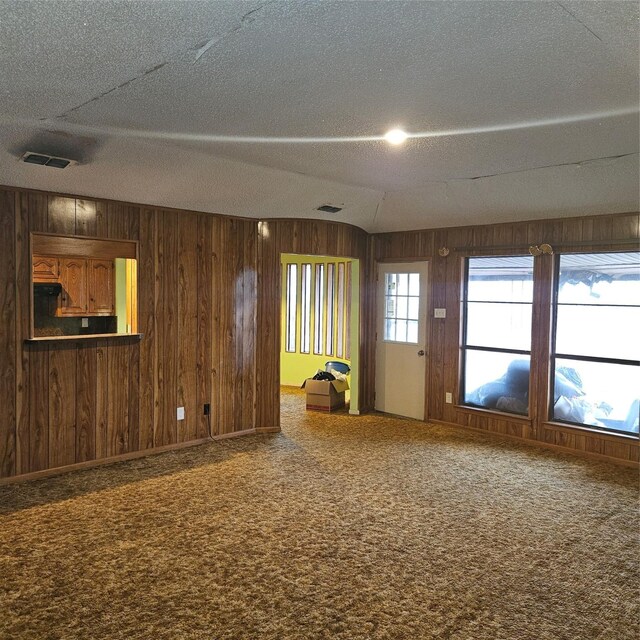 134 Hollie Dr, Red Oak, TX 75154 - spare room featuring vaulted ceiling, carpet floors, and a textured ceiling