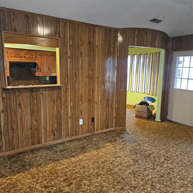 134 Hollie Dr, Red Oak, TX 75154 - carpeted spare room featuring wooden walls and a textured ceiling