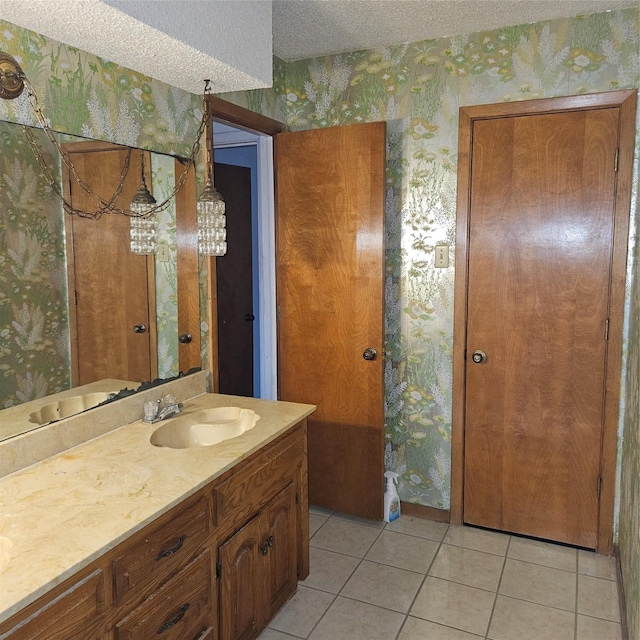 134 Hollie Dr, Red Oak, TX 75154 - bathroom with tile patterned floors, a textured ceiling, and vanity