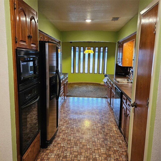 134 Hollie Dr, Red Oak, TX 75154 - kitchen with sink, a textured ceiling, and black appliances