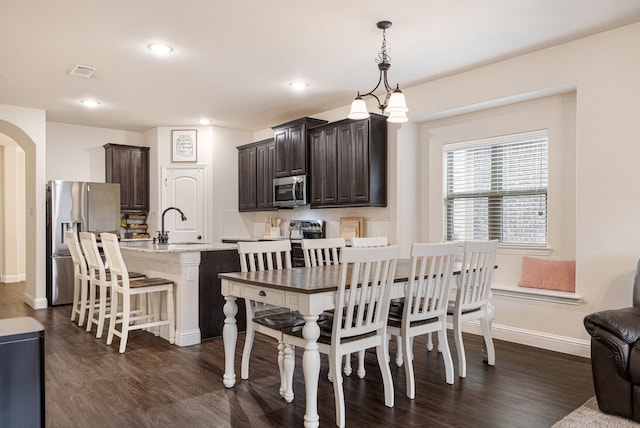 dining space with sink and dark wood-type flooring