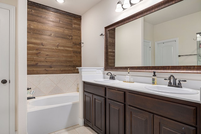 bathroom with vanity, tile patterned flooring, and a bathtub