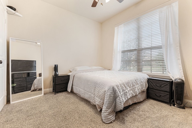 carpeted bedroom featuring lofted ceiling and ceiling fan