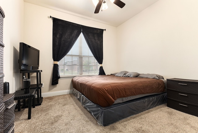 bedroom with lofted ceiling, light colored carpet, and ceiling fan