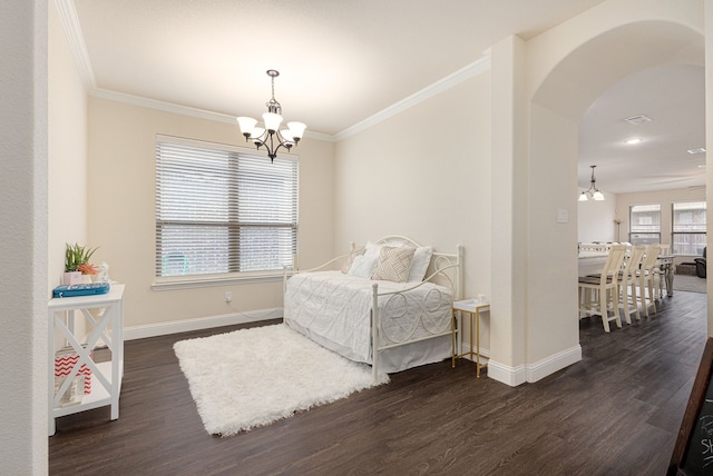 bedroom with crown molding, dark hardwood / wood-style flooring, and a chandelier