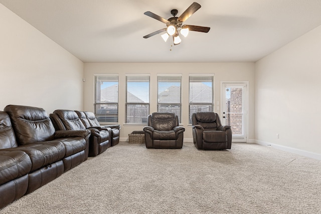 carpeted living room with ceiling fan