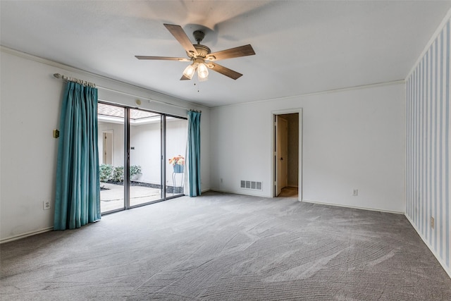 carpeted empty room featuring crown molding and ceiling fan