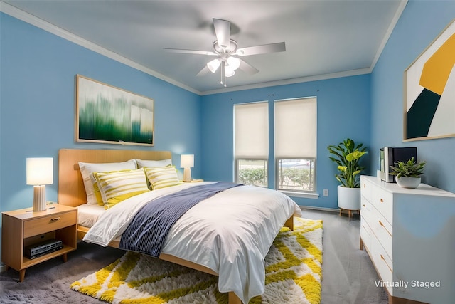 bedroom featuring ornamental molding, ceiling fan, and dark colored carpet