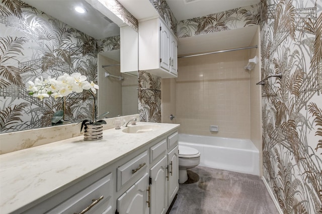 full bathroom with vanity, tiled shower / bath combo, and toilet