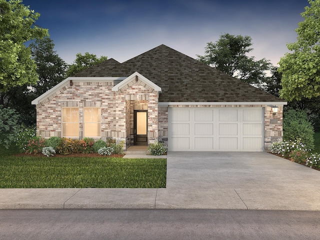 view of front of house with a yard and a garage